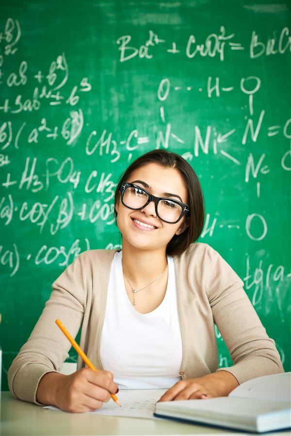 teachers sitting in front of chalk board